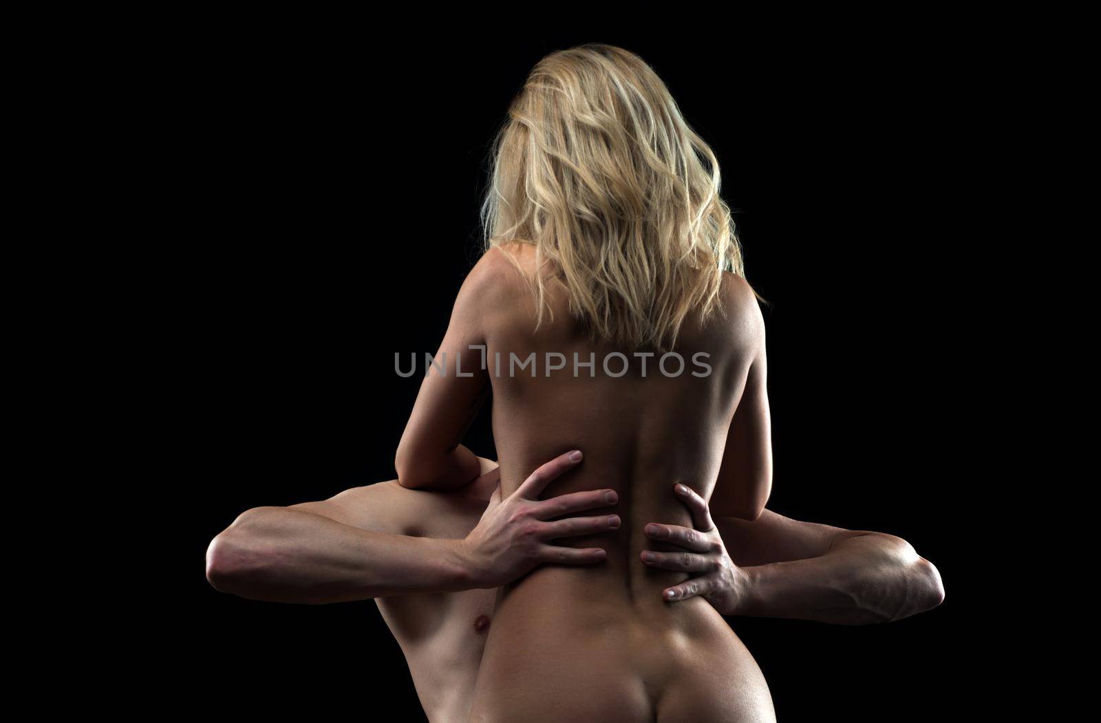 Passion couple in love embracing on black. by Tverdokhlib