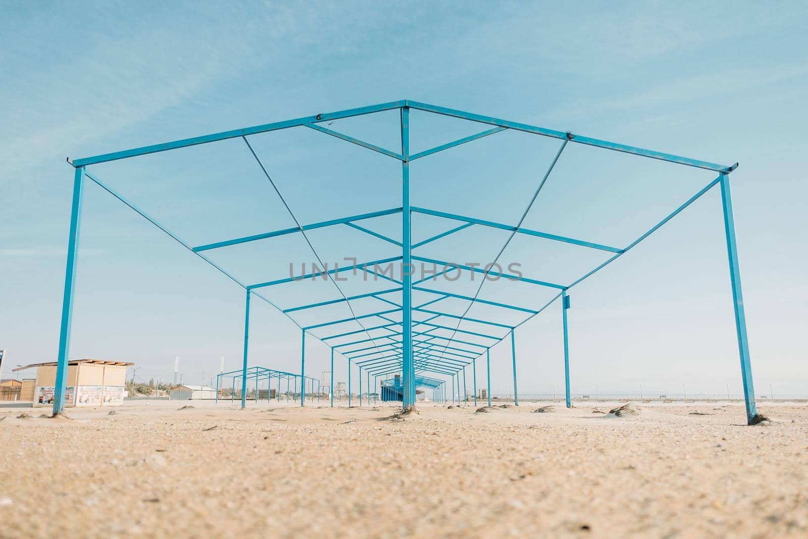 Minimalistic geometric metal construction on sand beach.