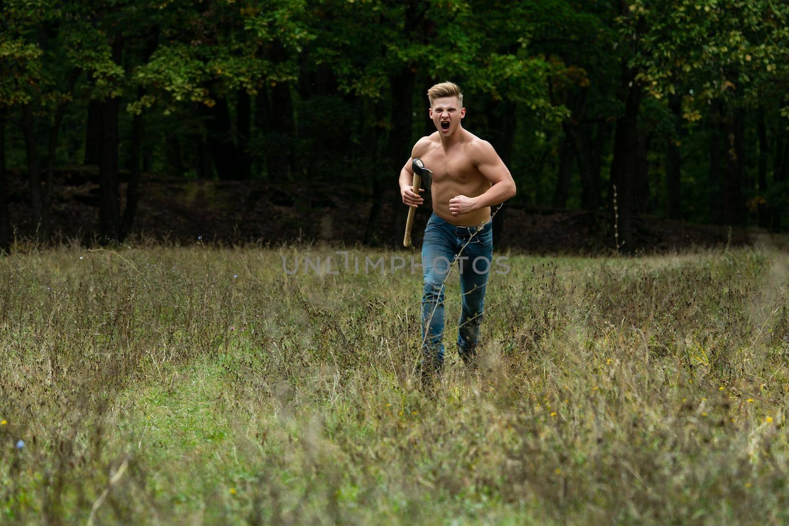 Lumberjack muscled young man run. Shirtless athletic naked guy running, nature outside. by Tverdokhlib