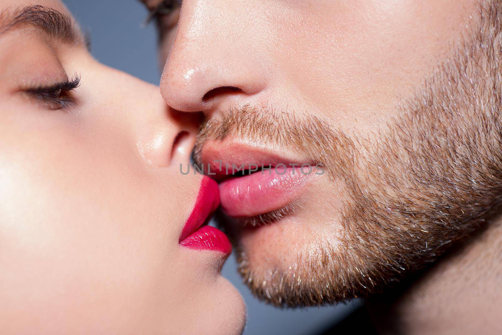 Man with woman kisses, macro, cropped of face. Sensual couple kissing. Kiss lovers lips. by Tverdokhlib