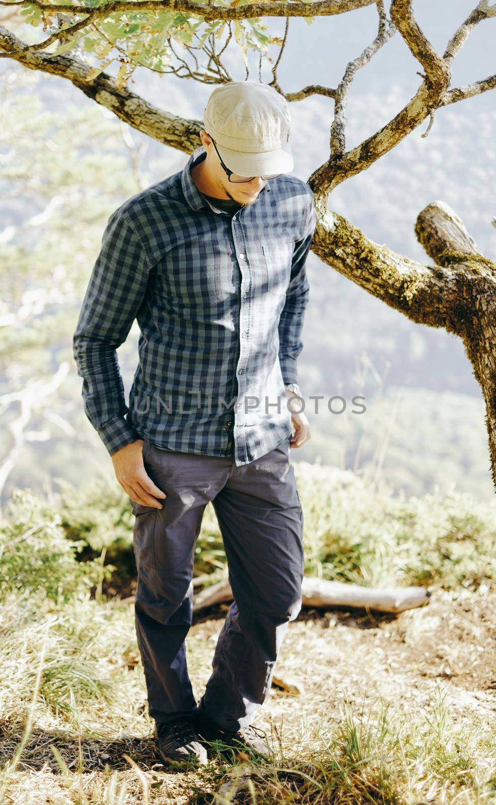 Explorer young man walking in pine woods.