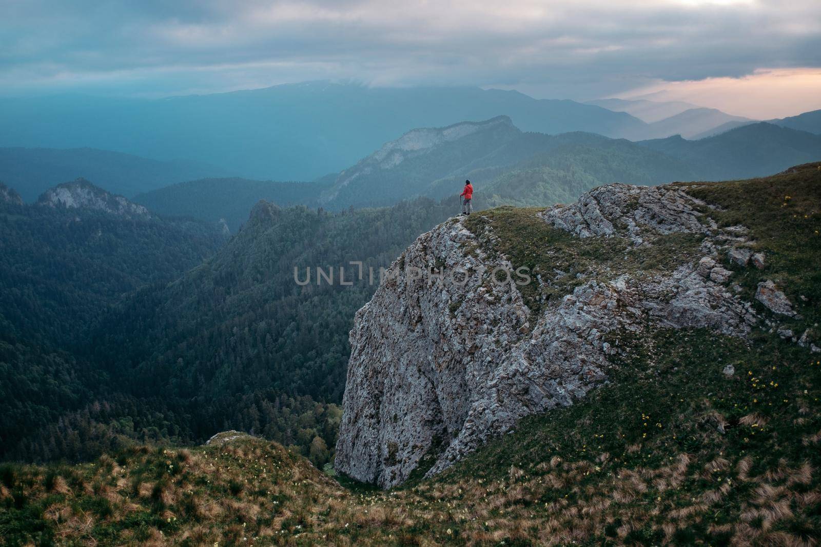 Small figure of hiker on mountain. by alexAleksei