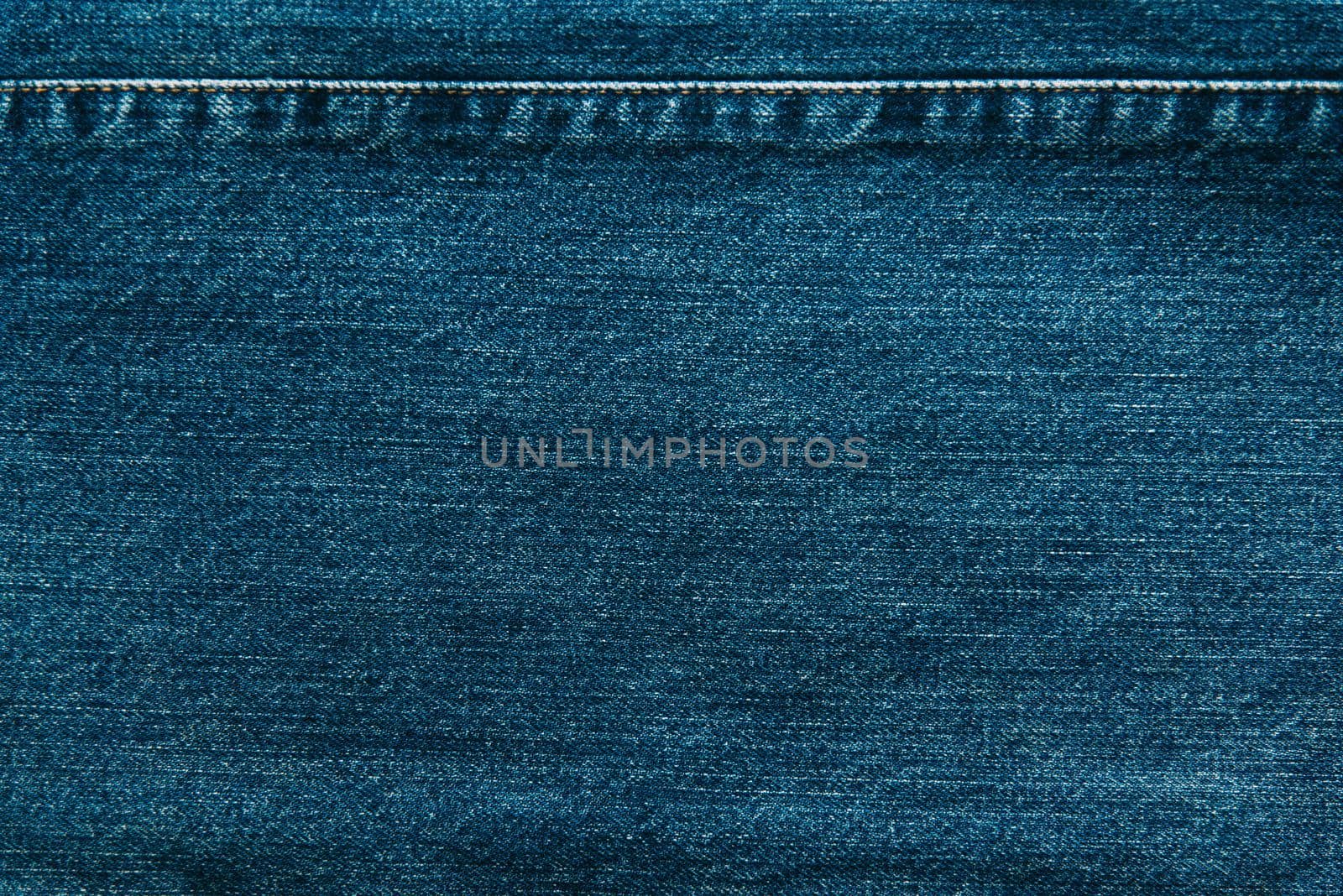 Cloth blue jeans denim texture background, closeup.