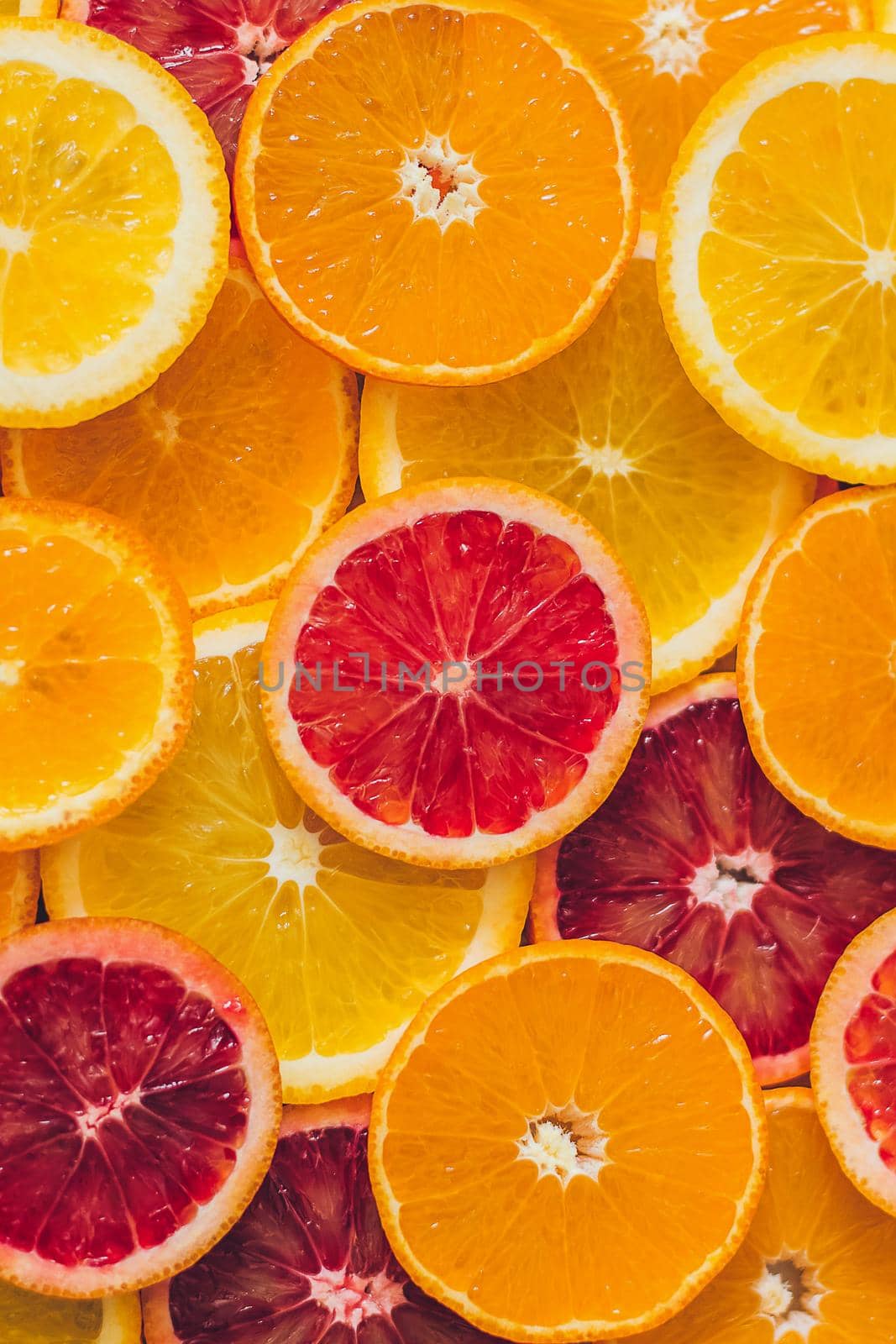 Juicy whole lemons, oranges and grapefruits and freshly cut half. Top view