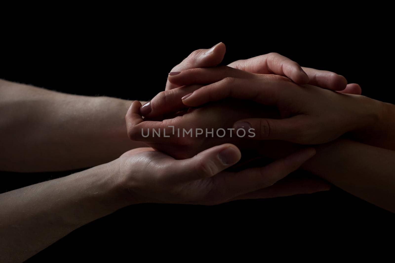 Concept of salvation. Hands of two people rescue, help. Helping hand, support. Isolated arm on black, charity. Devoted and empathy. Couple relationship. by Tverdokhlib