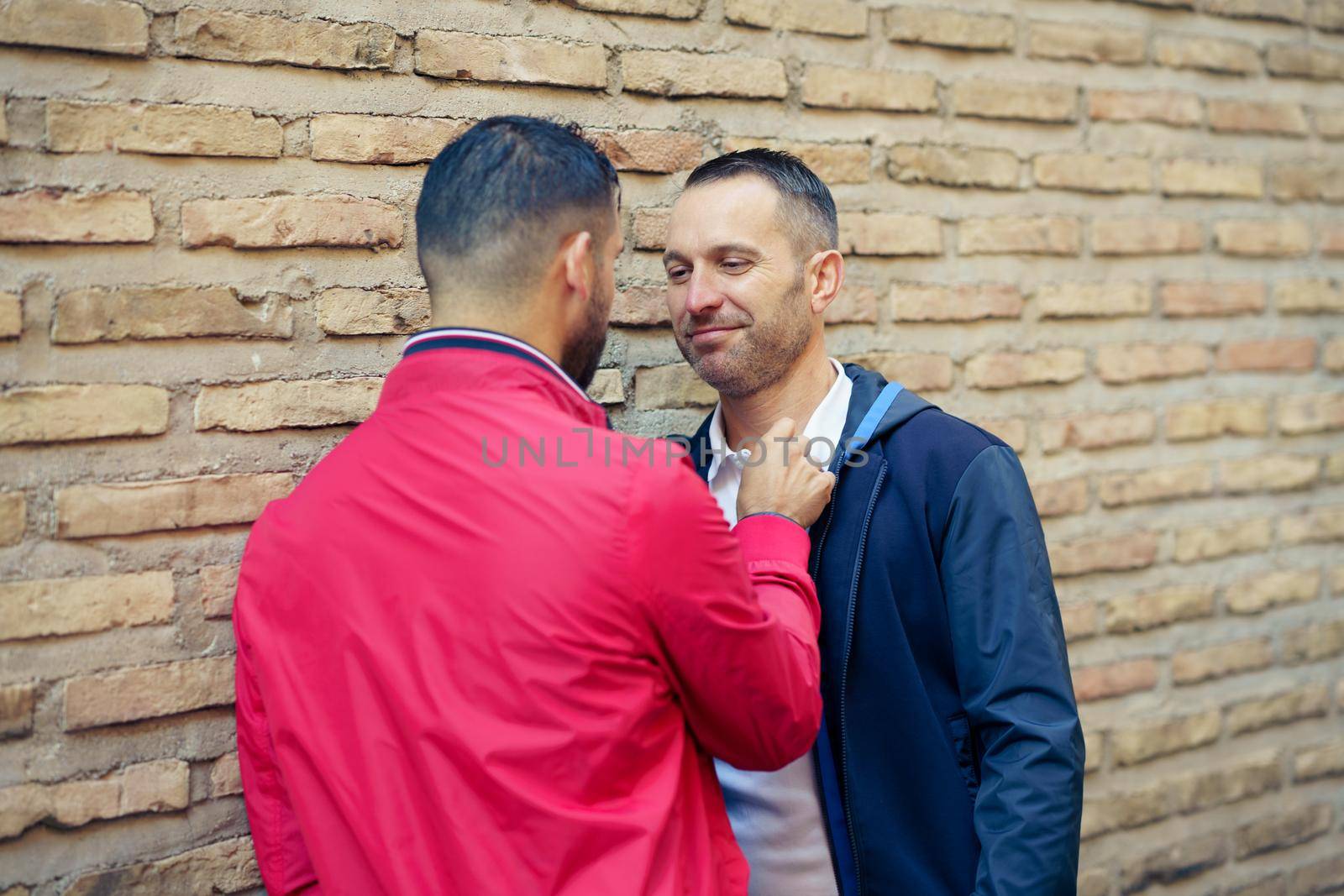 Gay couple in a romantic moment on the street. LGTB relationship concept.