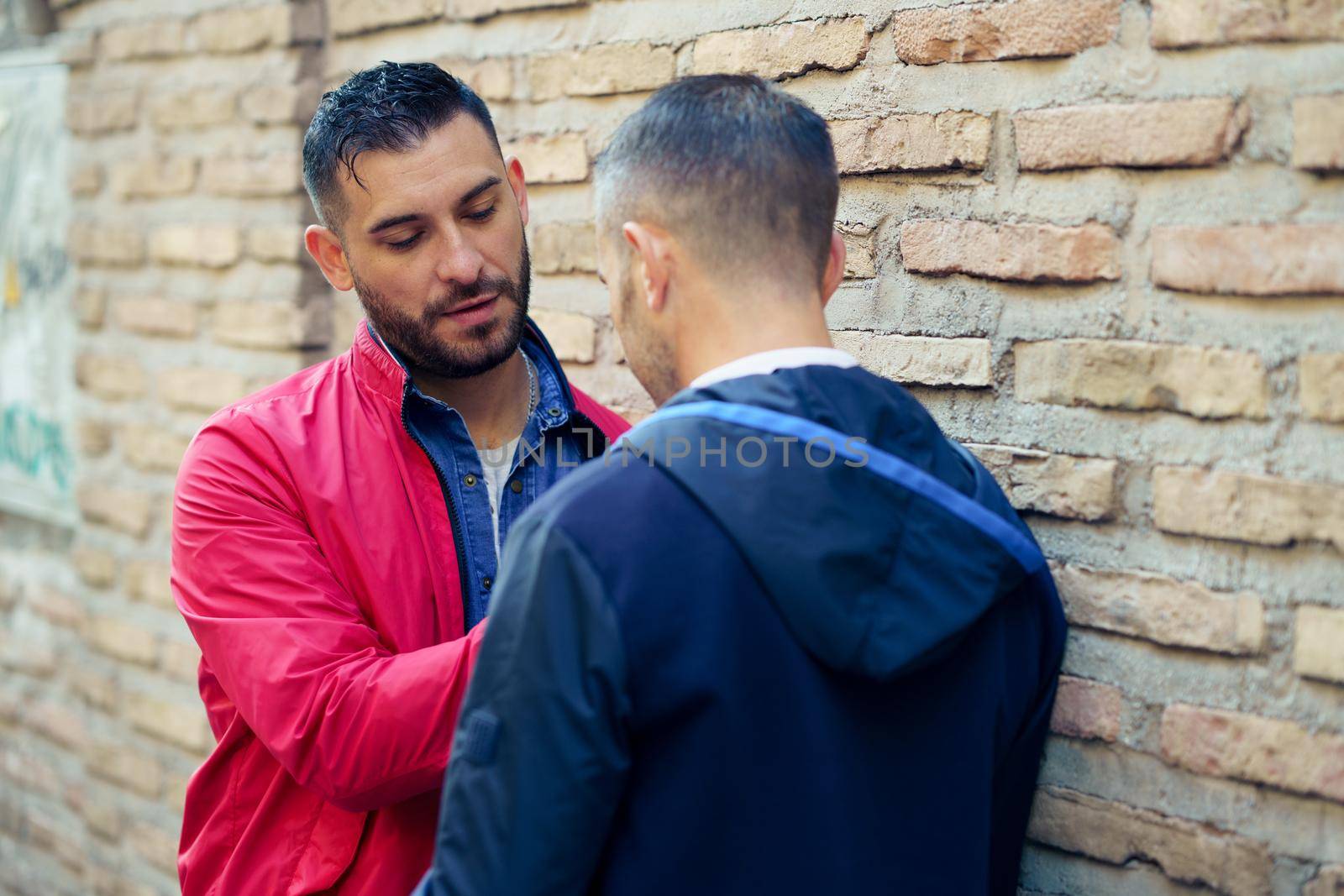 Gay couple in a romantic moment on the street. LGTB relationship concept.