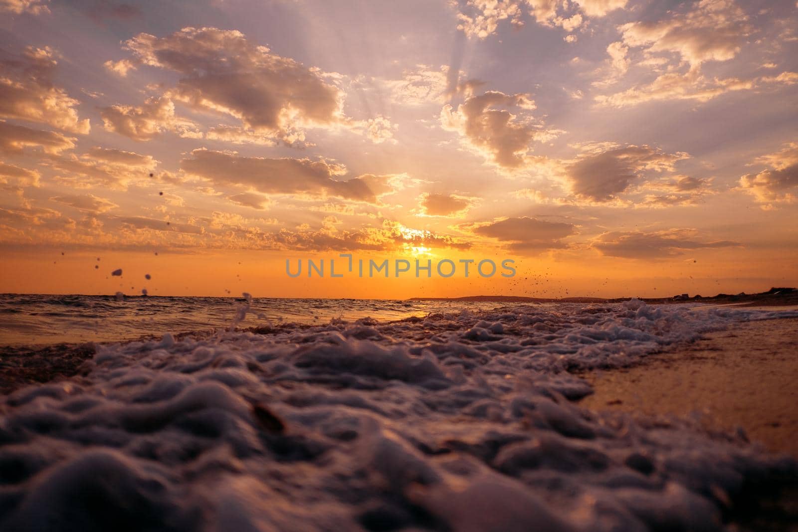 Close-up of sea waves and sunset. by alexAleksei