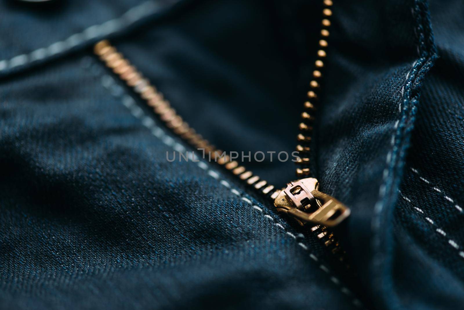 Zipper of denim jeans, closeup detail.
