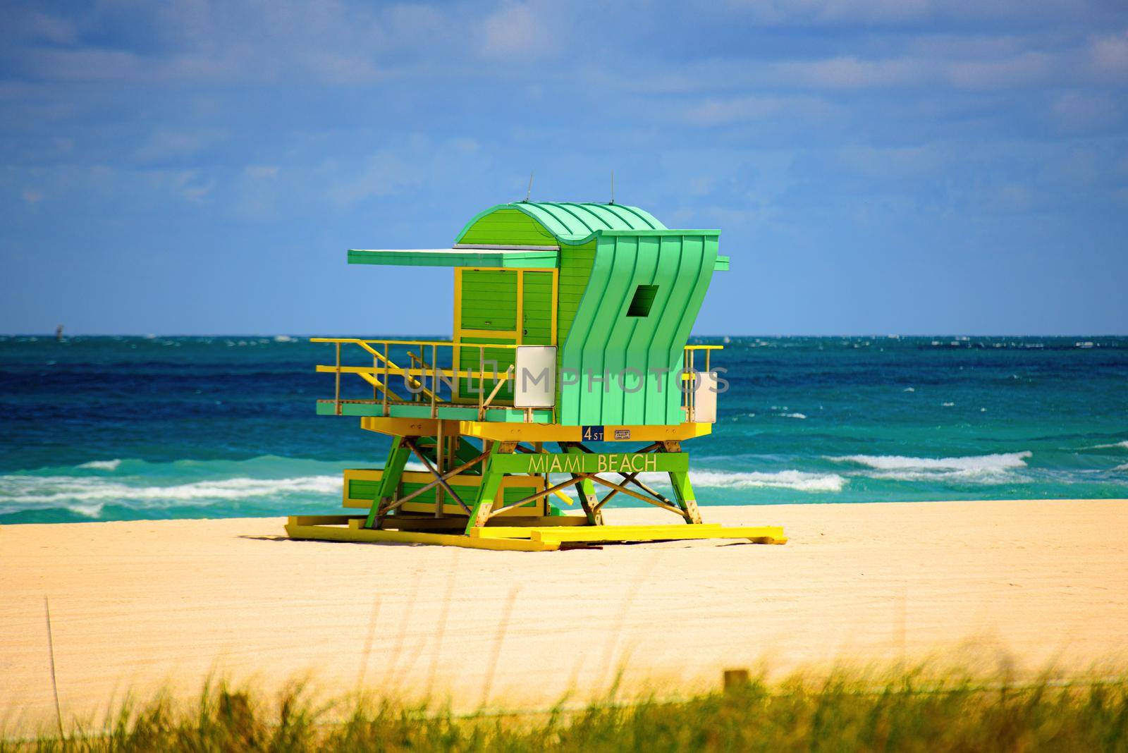 Miami Beach with lifeguard tower and coastline with colorful cloud and blue sky