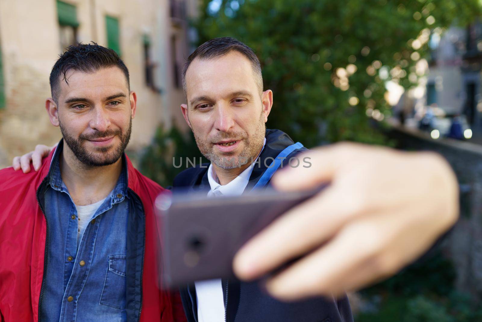 Gay couple making a selfie with their smartphone. by javiindy