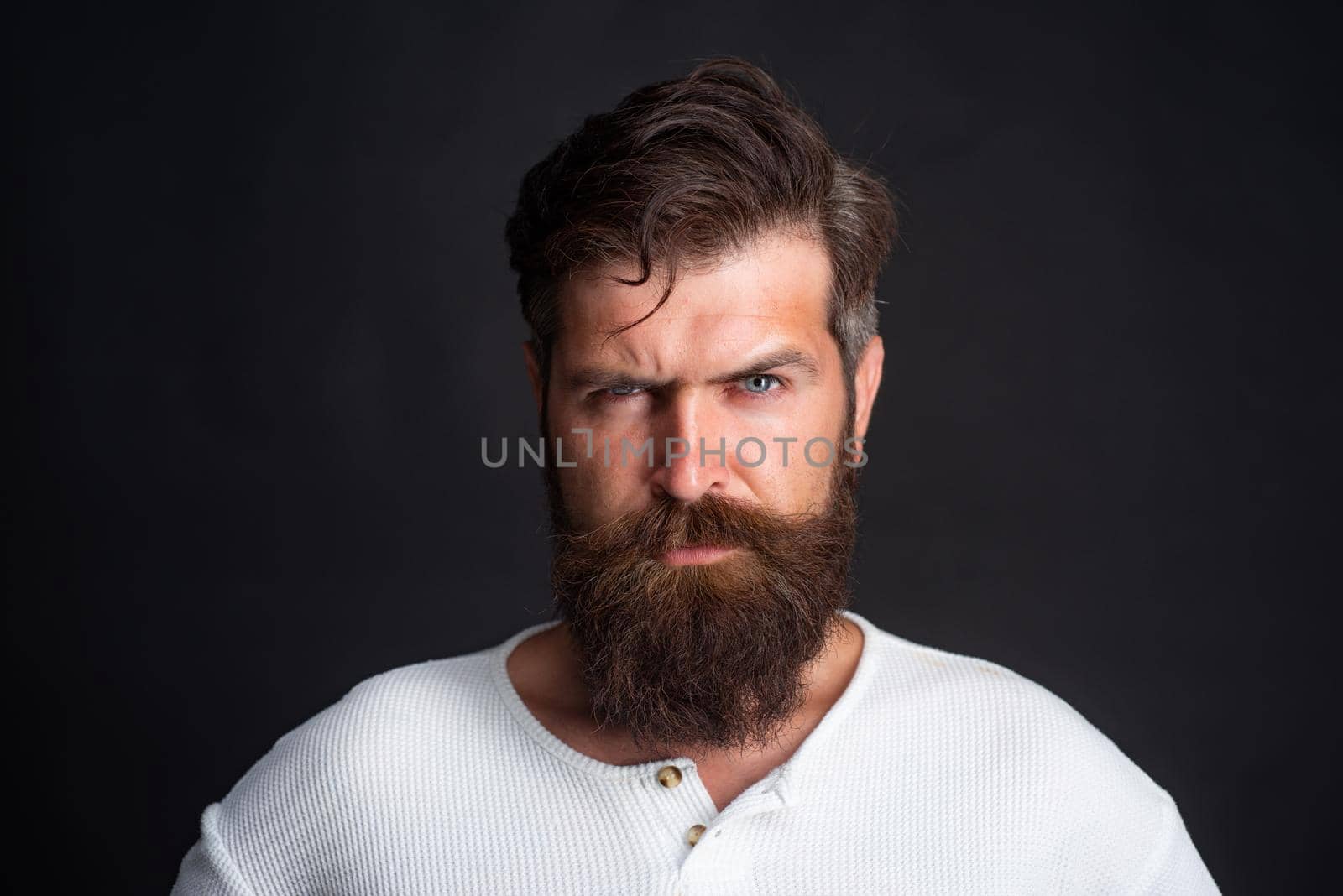 Young handsome man with long beard, mustache and trendy hairdo