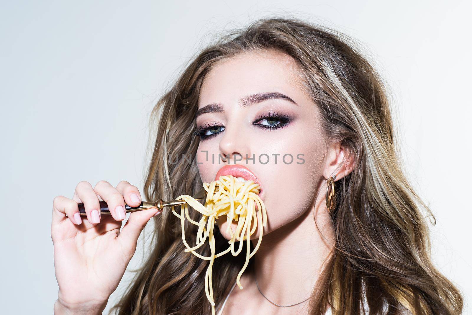 Sexy seductive cheeky girl eats a pasta