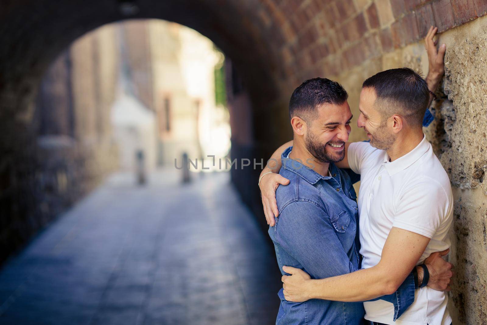 Gay couple laughing together in a romantic moment. Homosexual relationship concept.