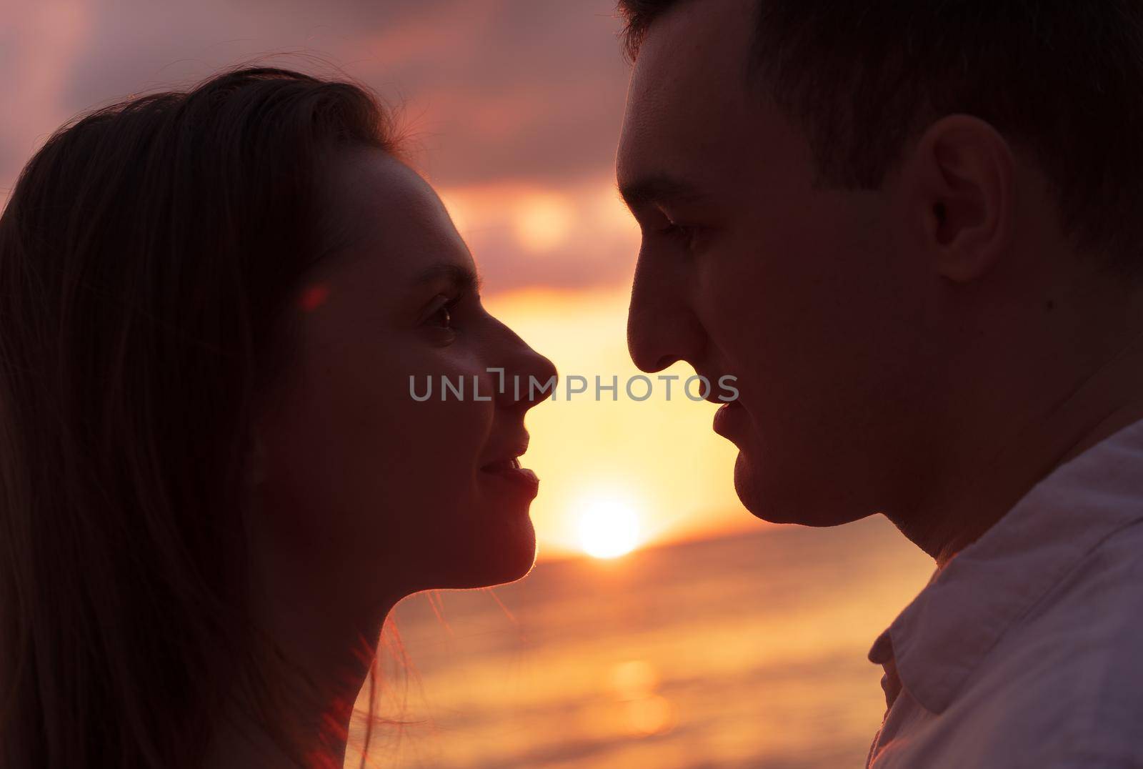 Romantic sensual young couple in love at the sunset, close up