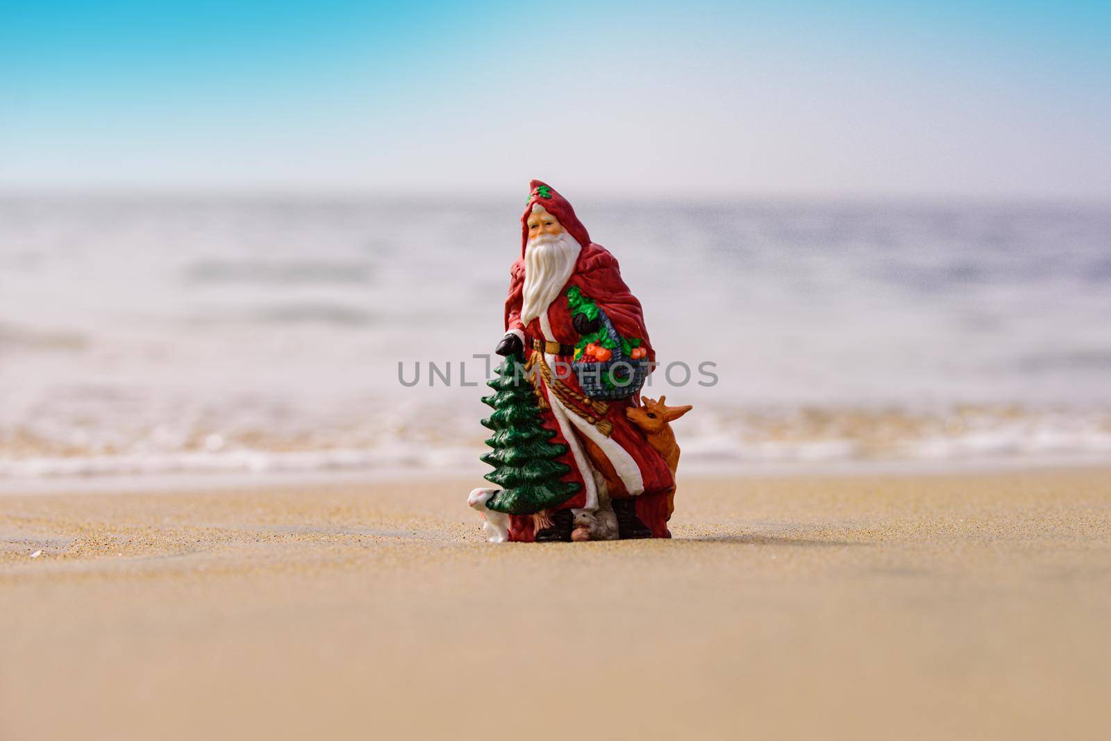 Summer Santa on sand. Xmas card. Holiday concept for New Year and Christmas