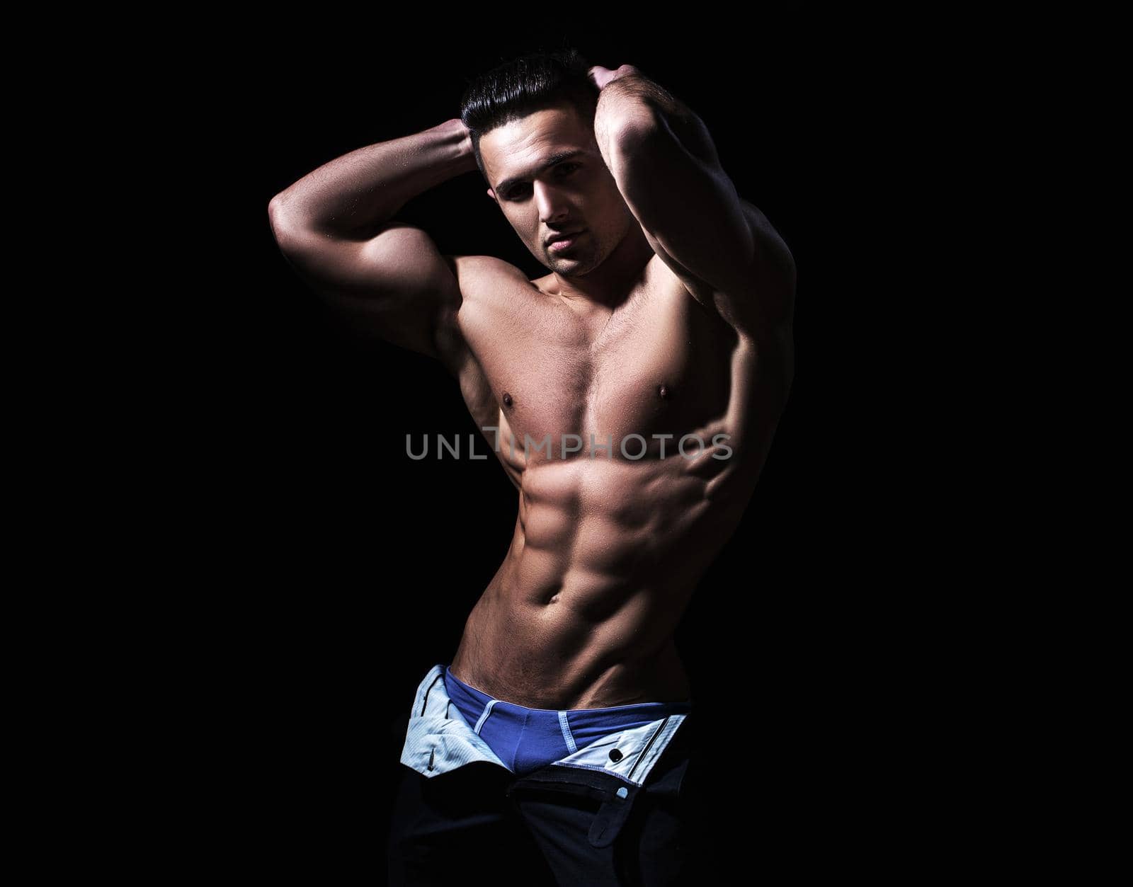 Shirtless athletic naked guy. Athletic young man showing his perfect naked body
