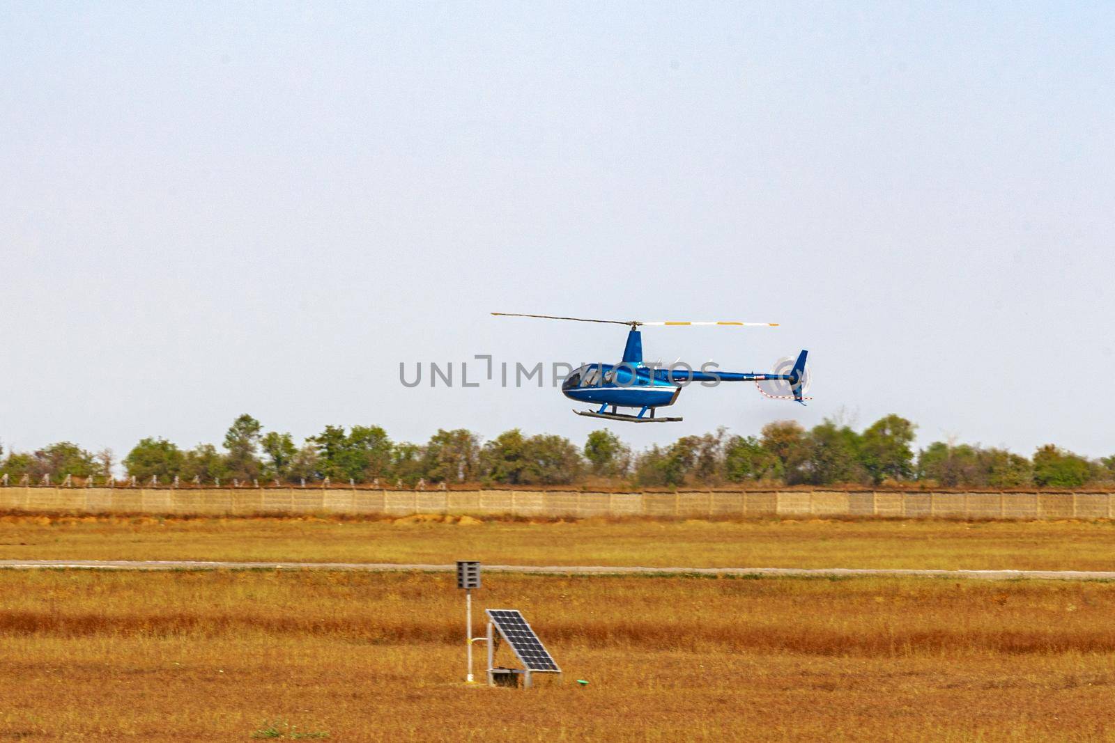 Helicopter flying in the blue sky during a sunny day