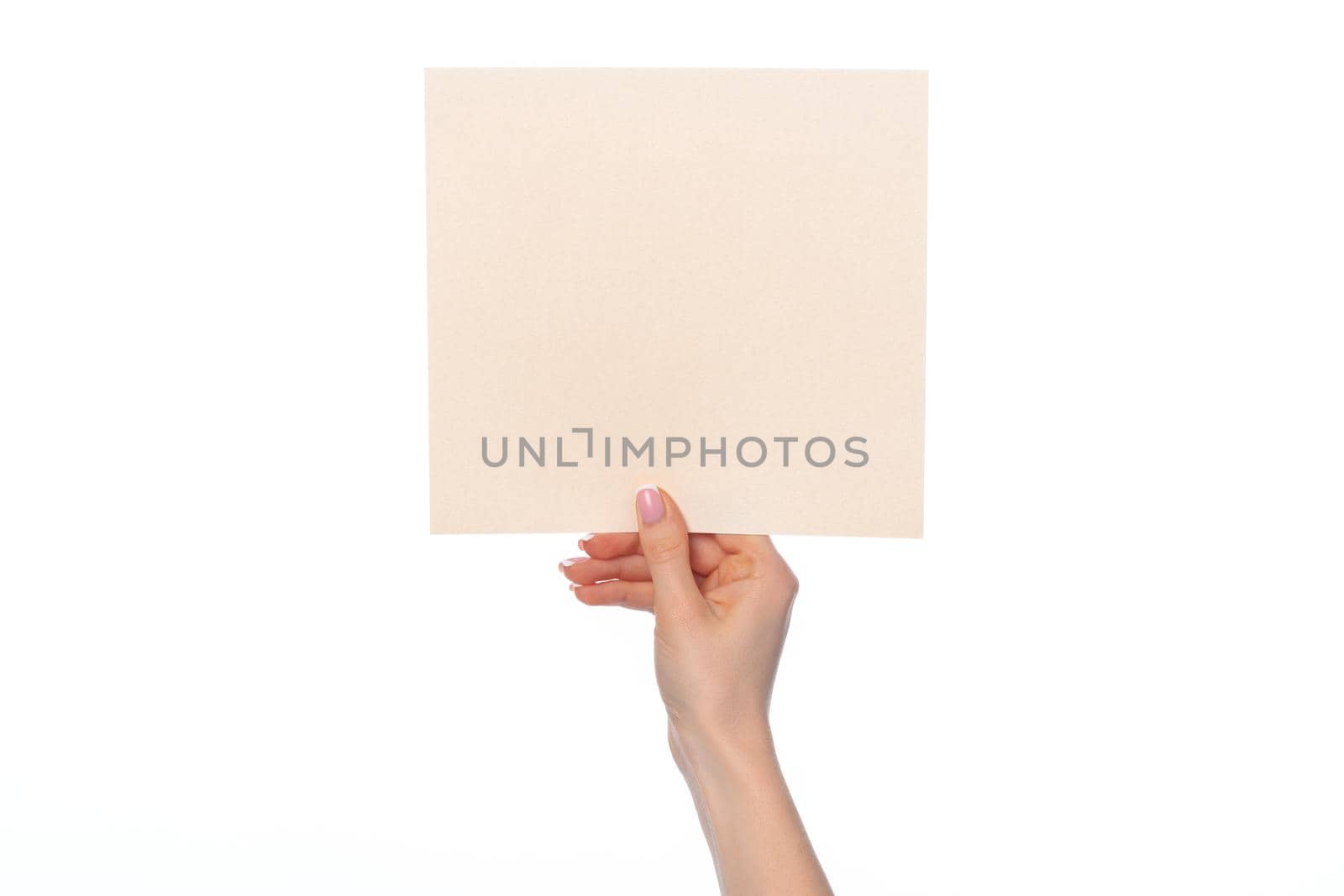 Female hand holding blank white sheet of paper isolated on white background