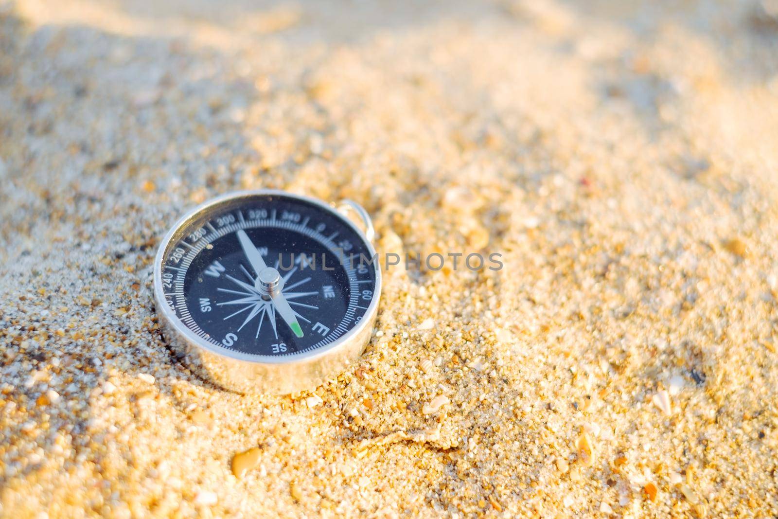 Travel compass on sand. by alexAleksei