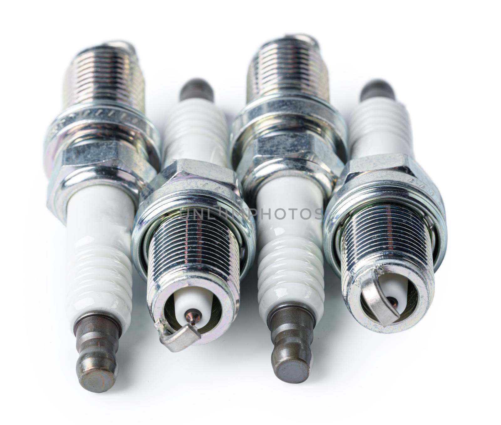 Car part. Spark plugs isolated on white. by Fabrikasimf