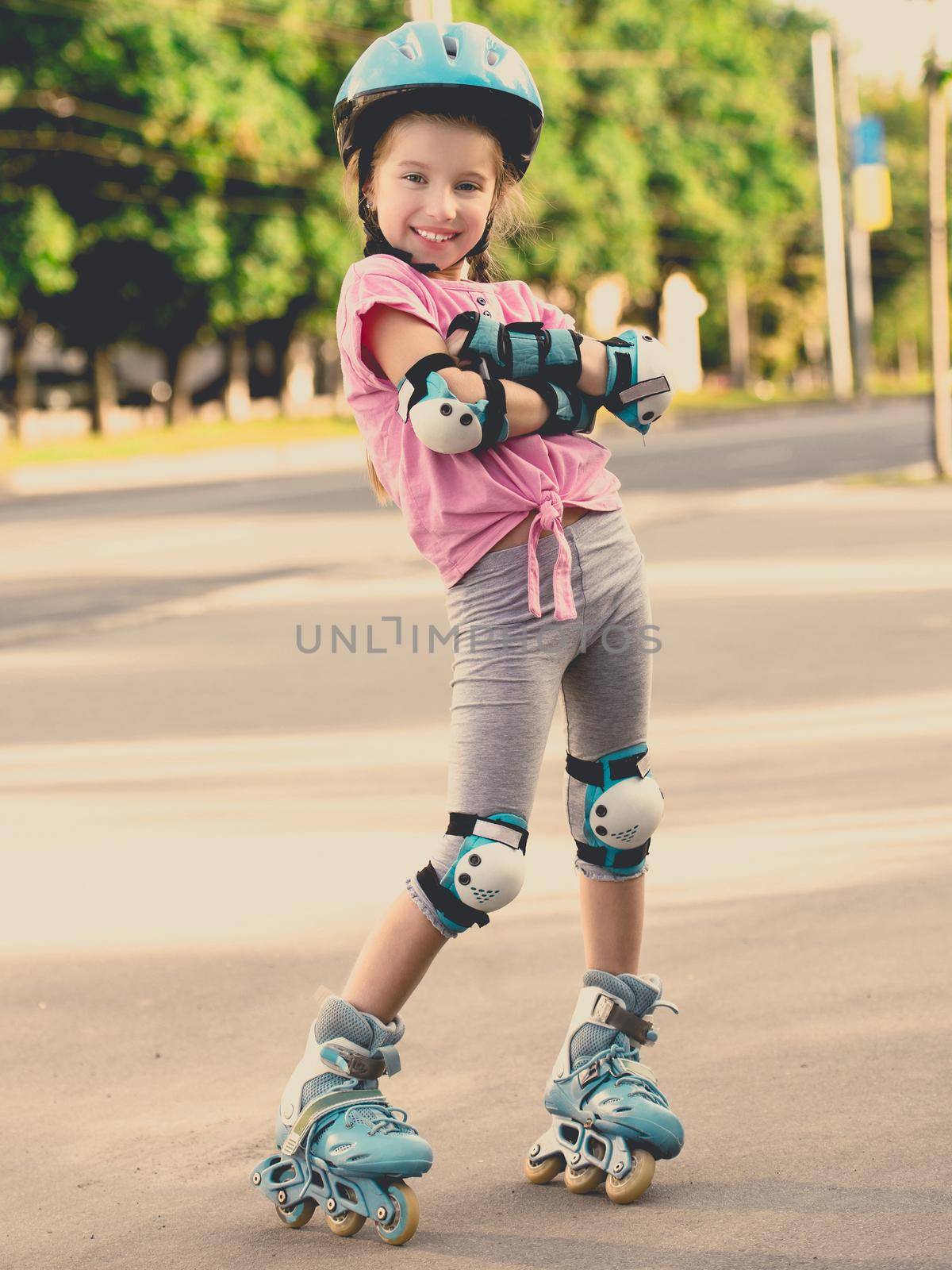 beautiful girl on the rollers in helmet and protection