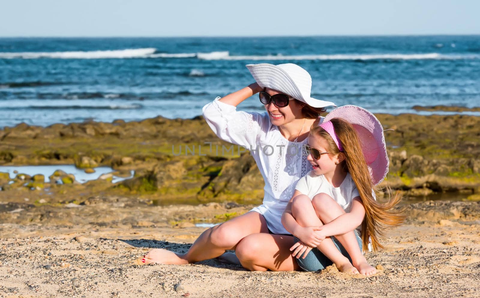 happy mother with daughter on the beach