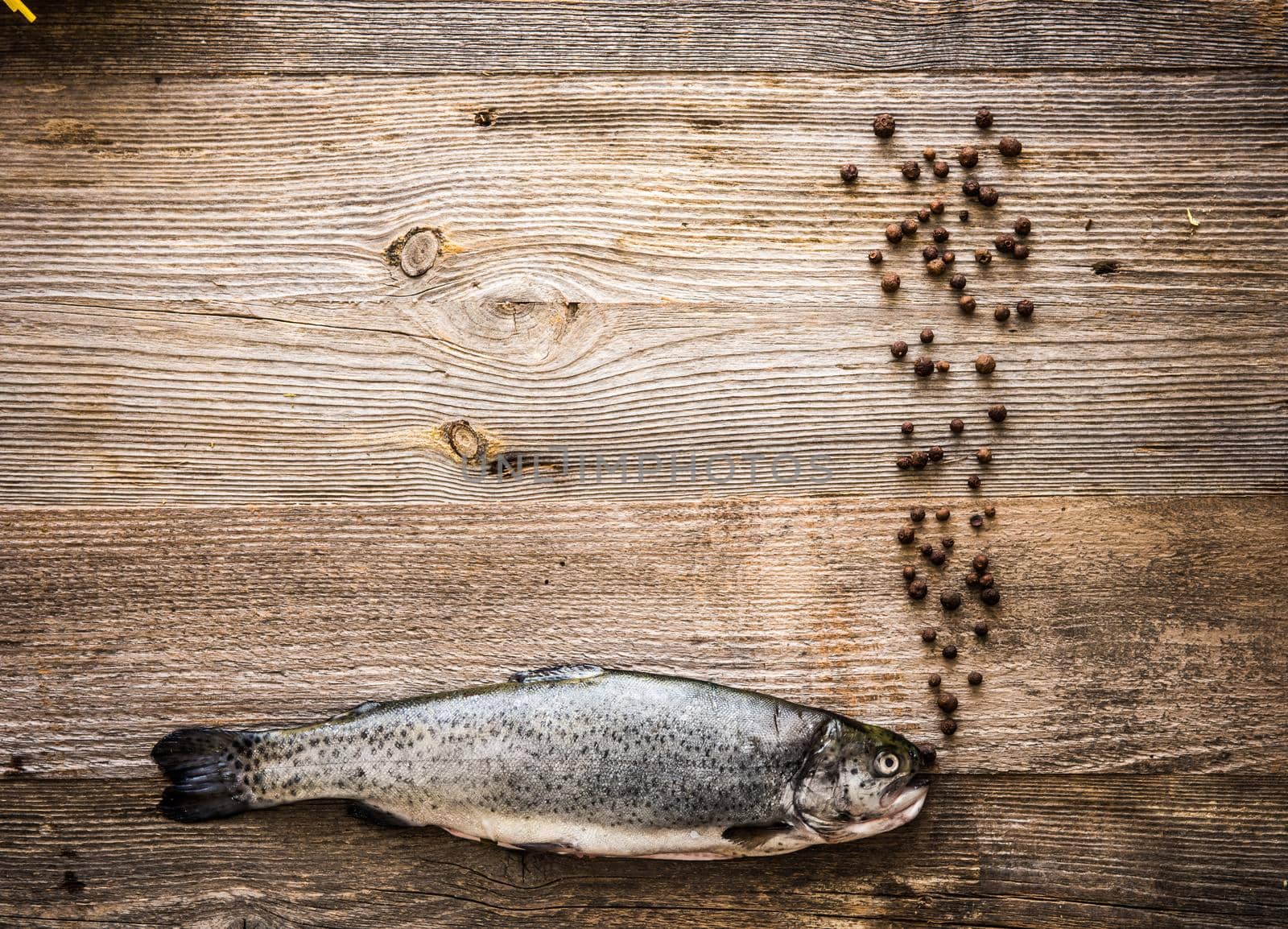 Fresh trout on a wooden table by GekaSkr