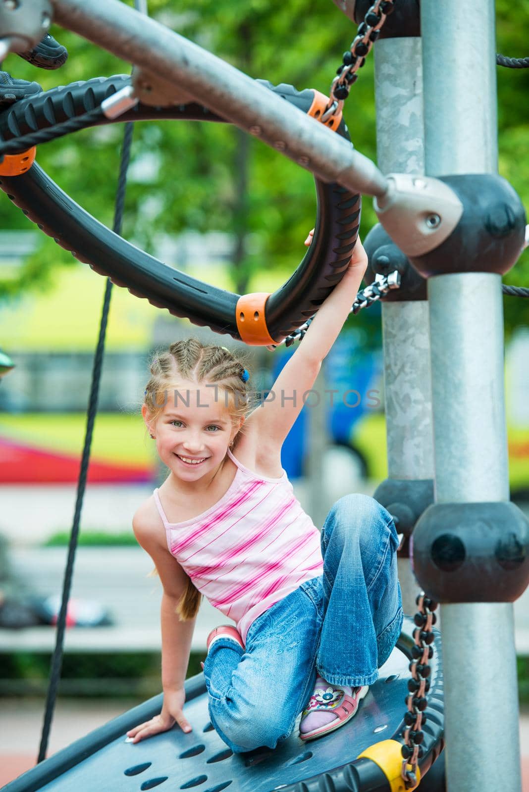 cute beautiful smiling little girl on a playground