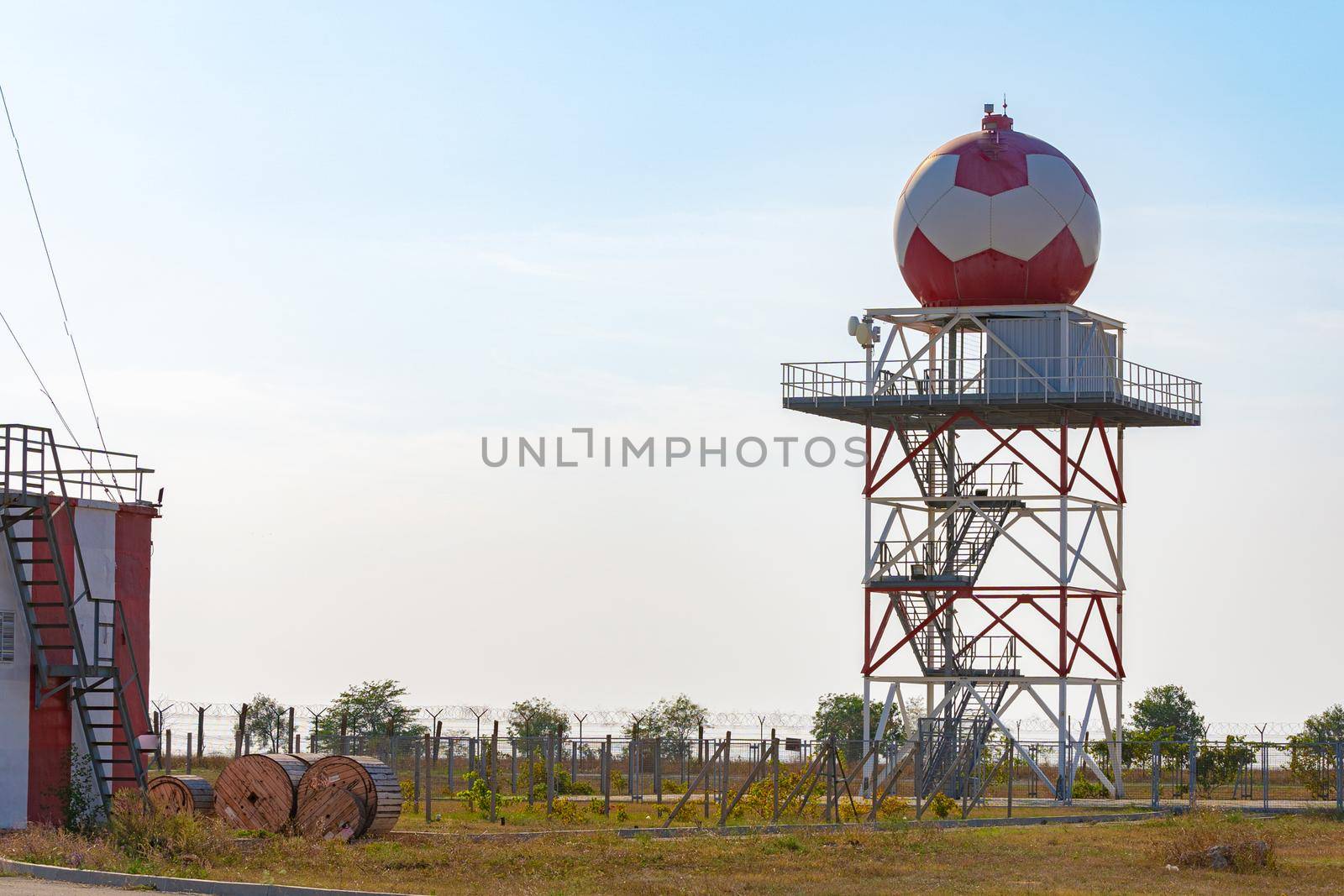 Aeronautical meteorological station tower with spherical radar at airport by Fabrikasimf
