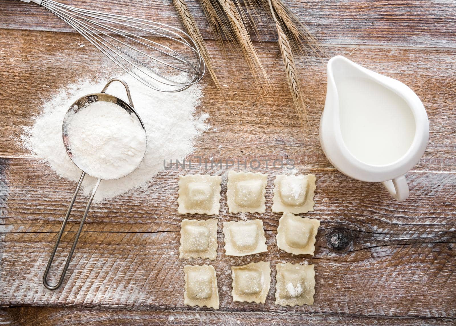 Tortellini on a wooden table with other products