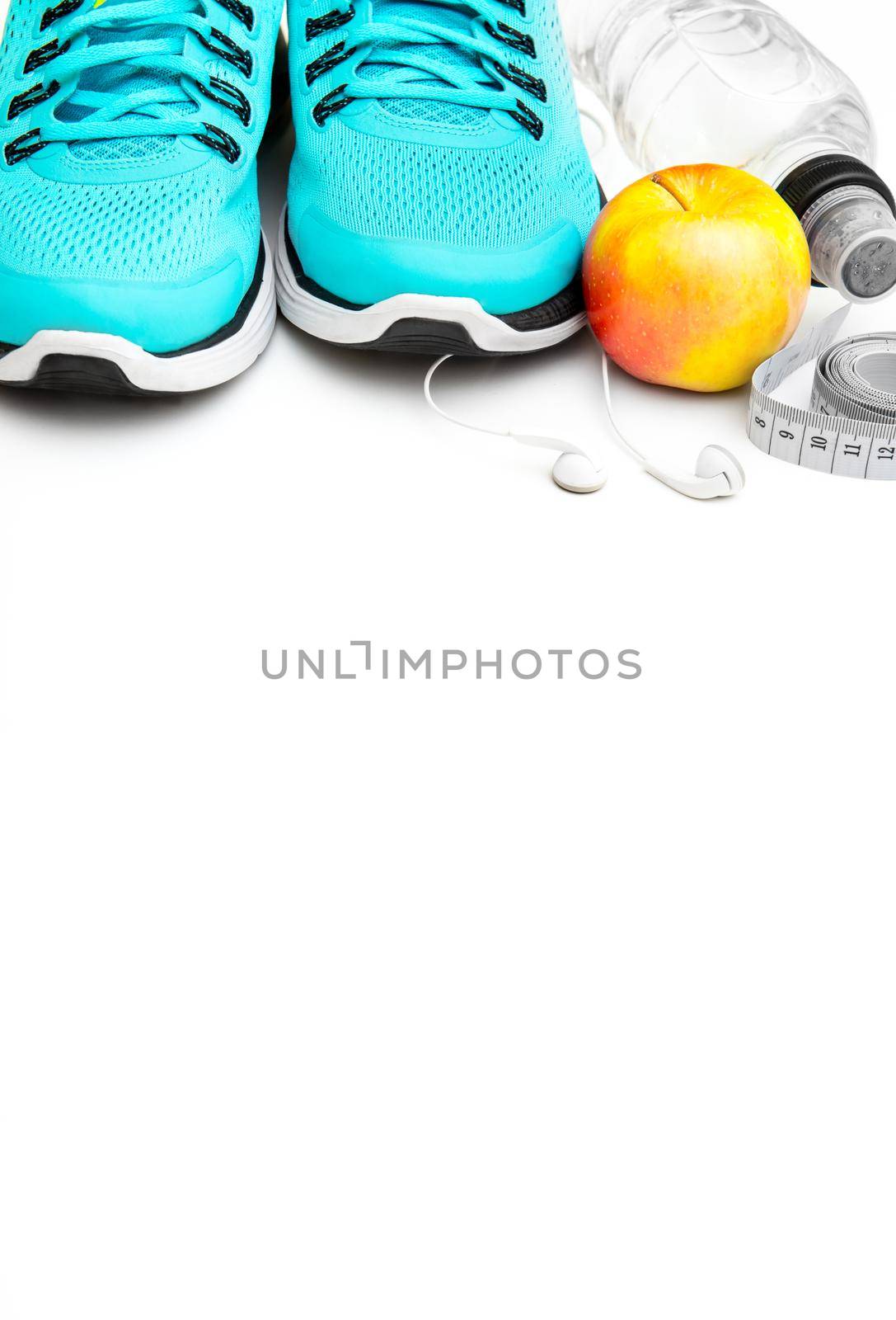 sport background: blue running shoes and apple with objects isolated on white background