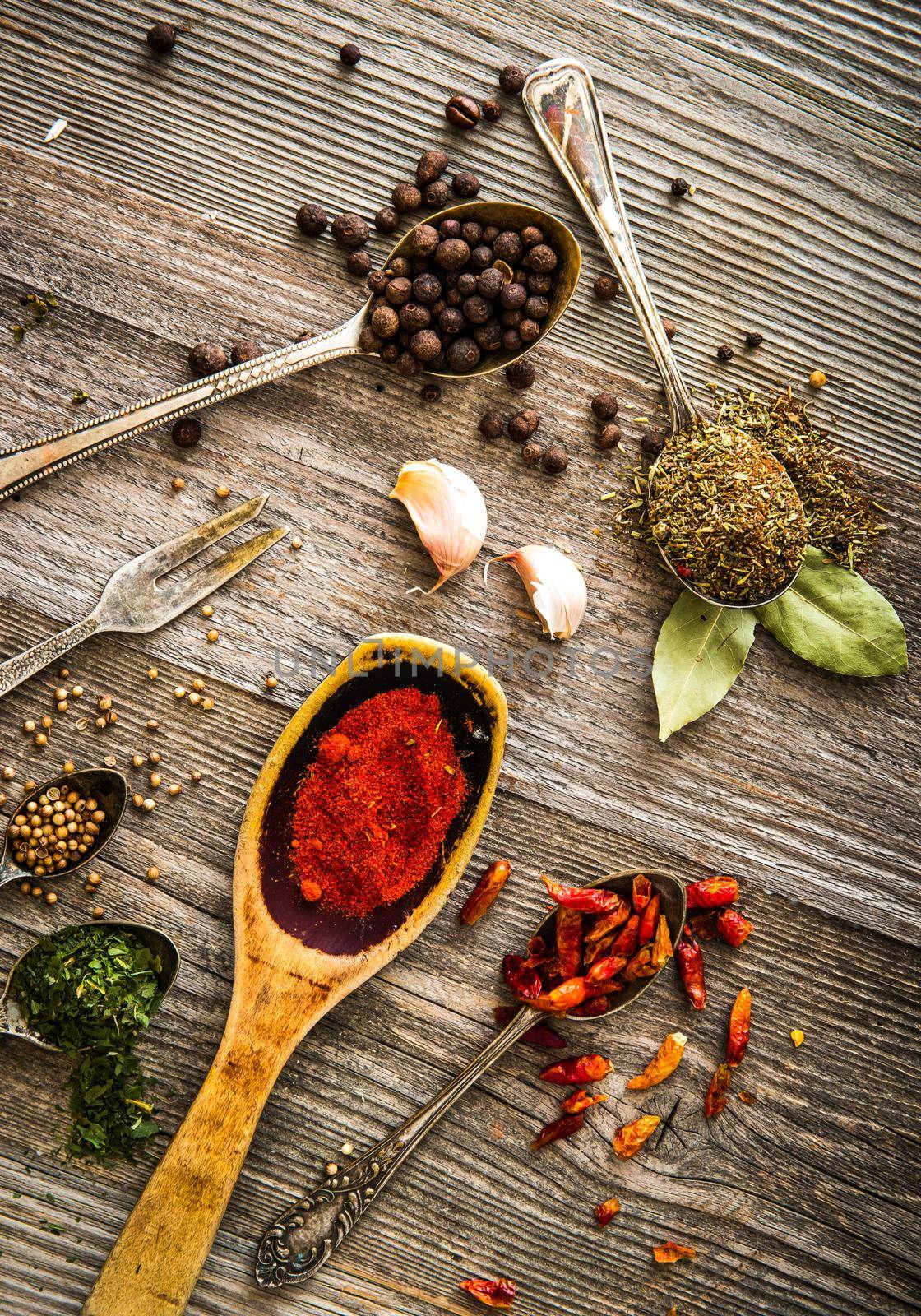 spices and herbs on a brown wooden table