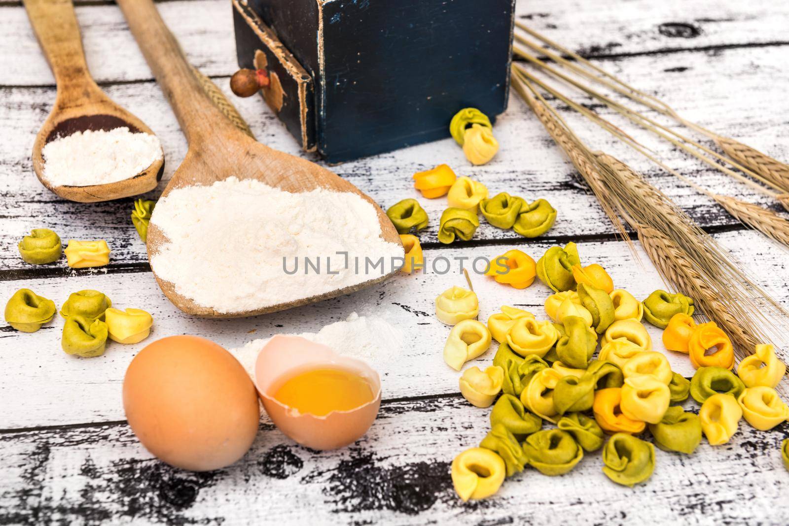 tortellini and other products on textured wooden table