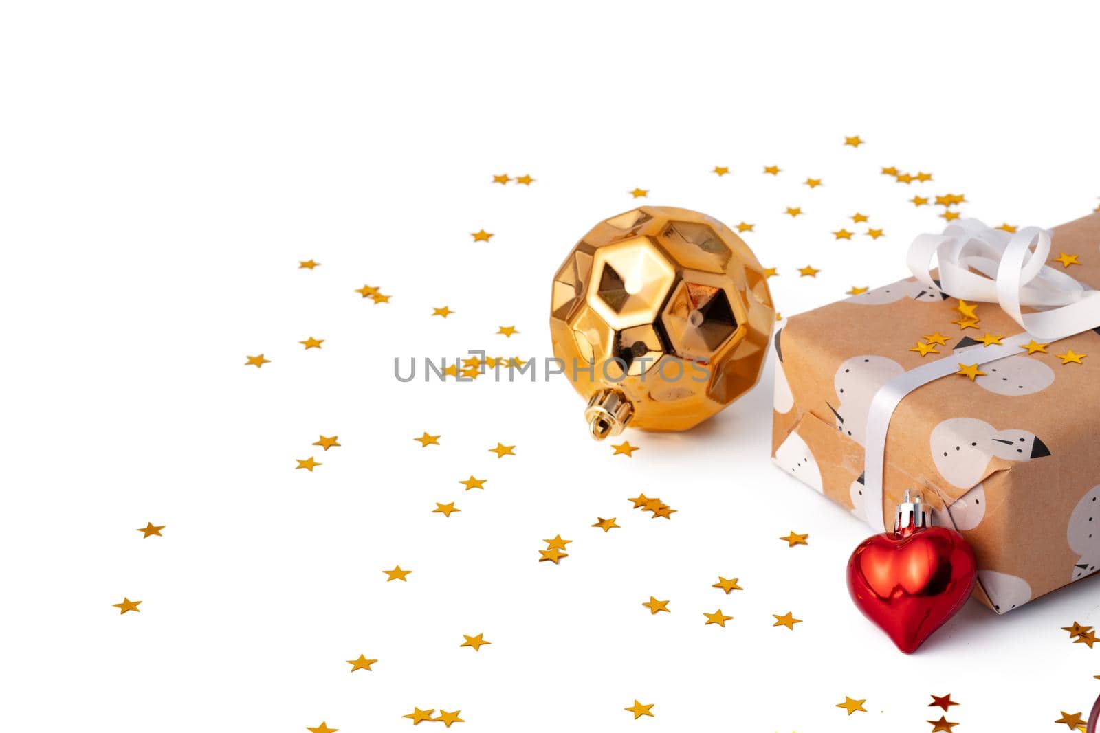 Christmas baubles and festive gift box isolated on white background, close up