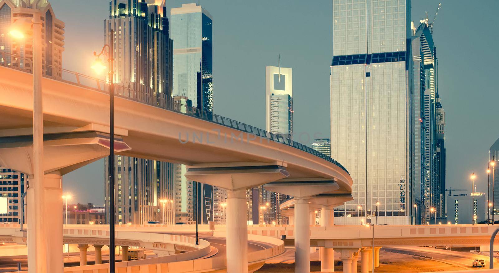 Skyscraper roads and bridge at the Sheikh Zayed Road in Dubai in the evening, United Arab Emirates
