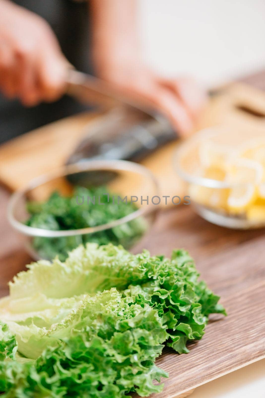 Unrecognizable woman cooking in the kitchen. Focus on foreground.