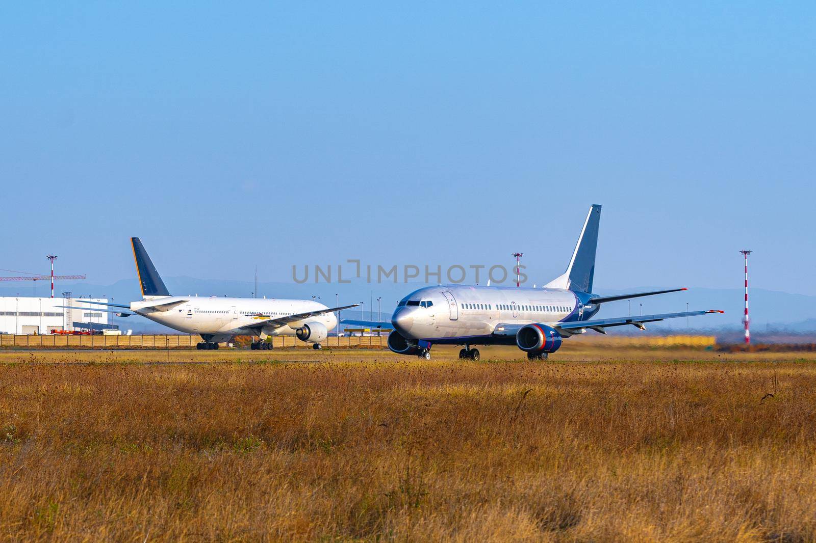 Passenger plane taking off from runway at airport on sunny day photo