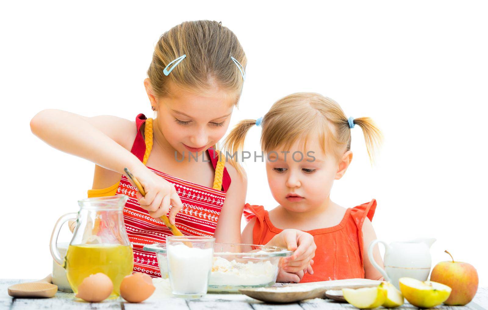 two little sisters cooking isolated on a white background