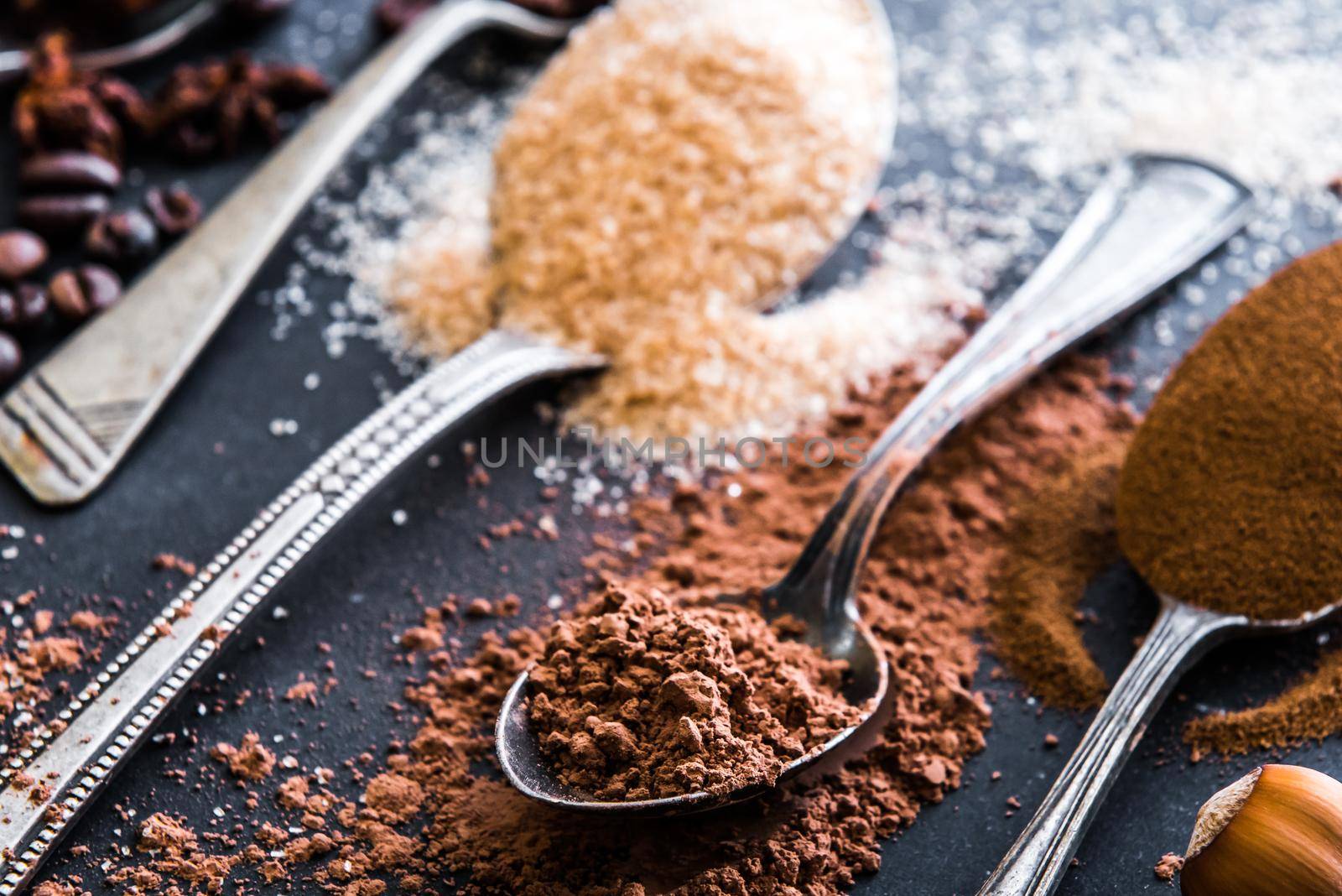 Chocolate powder cocoa and coffee spoons on the table by GekaSkr