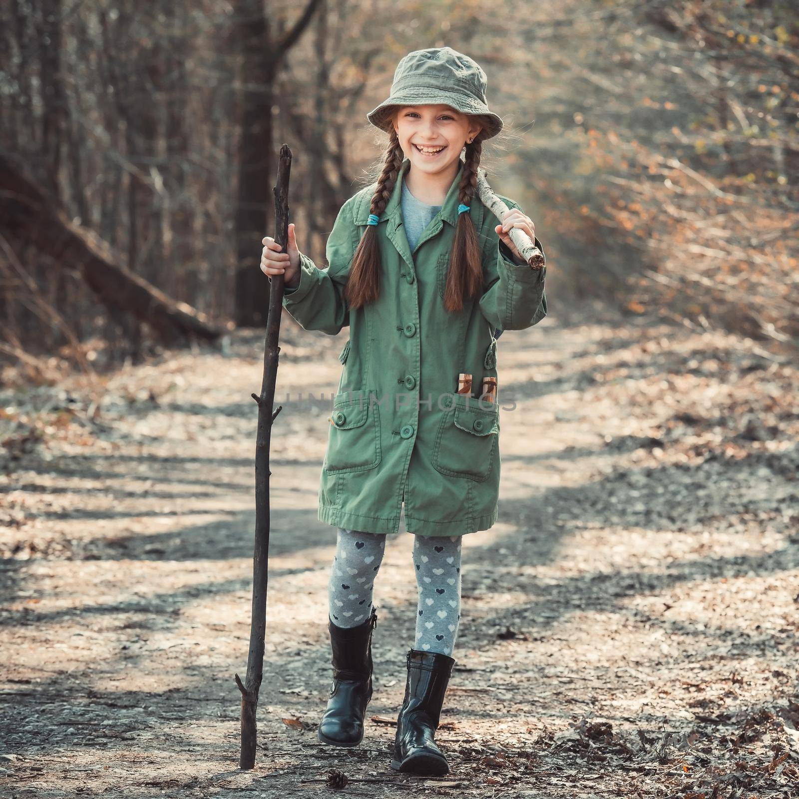 little girl goes through the woods with stuff, photo in vintage stylev