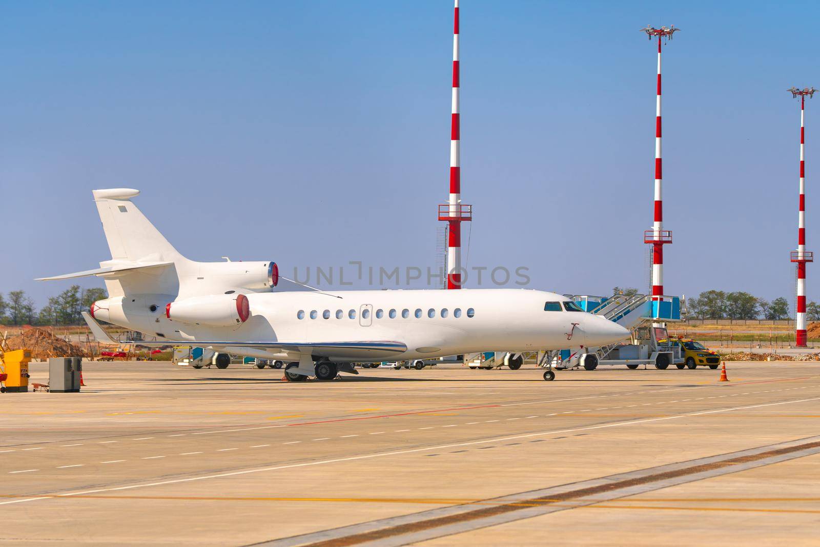 Airplane is parked near gate of airport terminal on sunny day