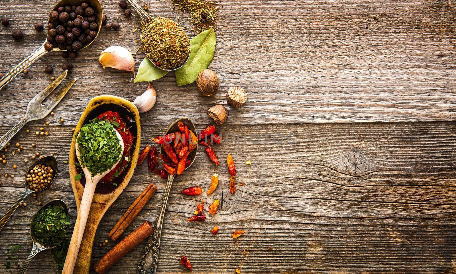spices and herbs on a brown wooden table