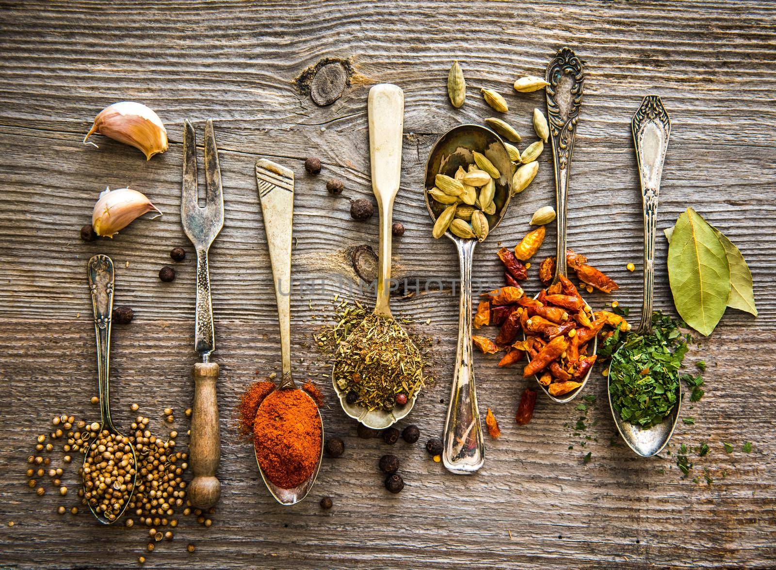spices in the spoons on a table by GekaSkr