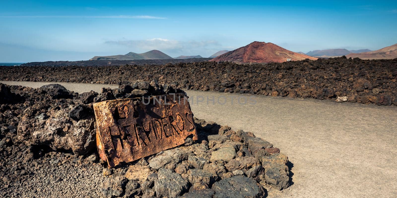 beautiful desert landscape with a metal sign Los Hervideros on Lanzarote island , Canary Islands