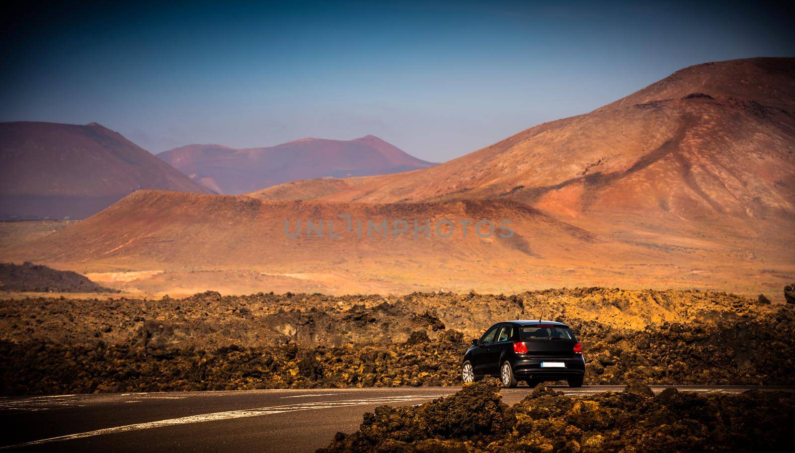 car on a mountain road in Lanzarote at sunset, Canary Islands