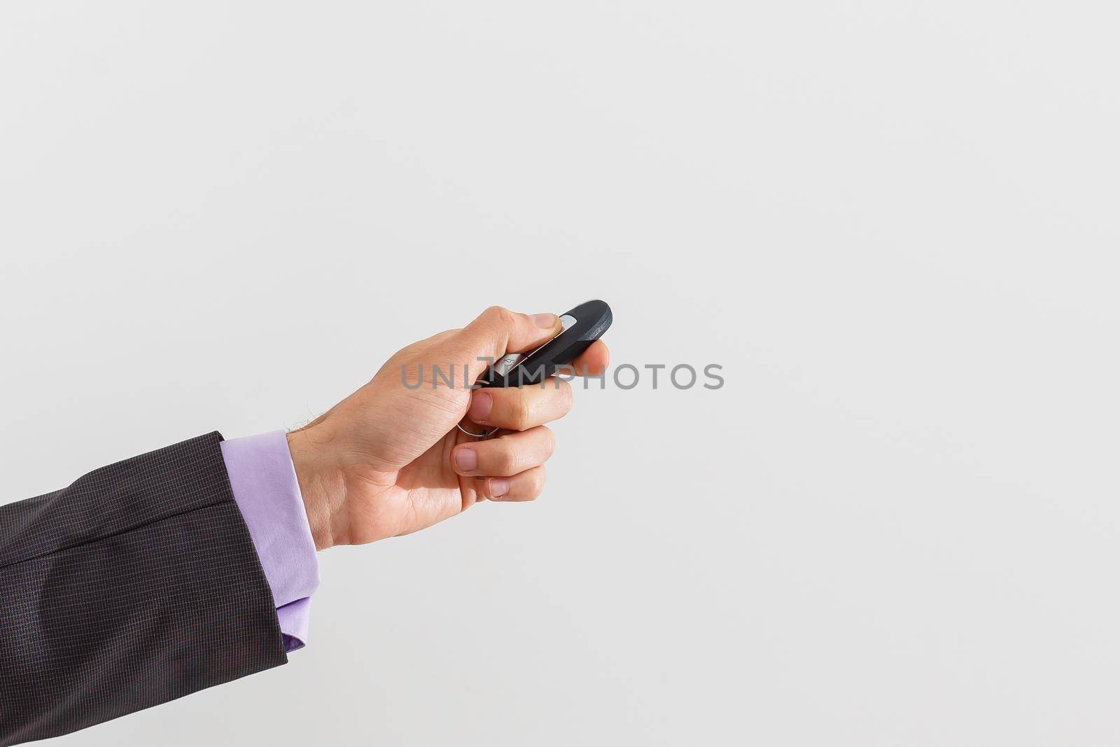 A businessman offering a bunch of car keys and car alarm system by Andelov13