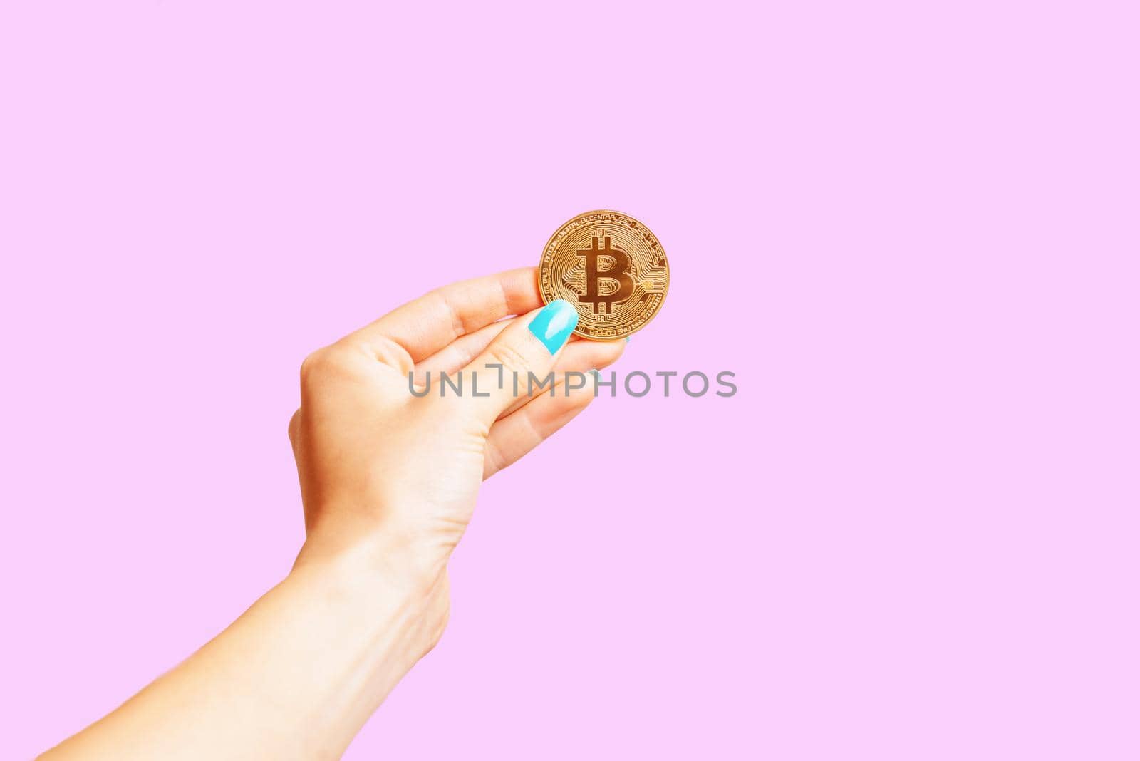 Hand holding one gold bitcoin. by alexAleksei