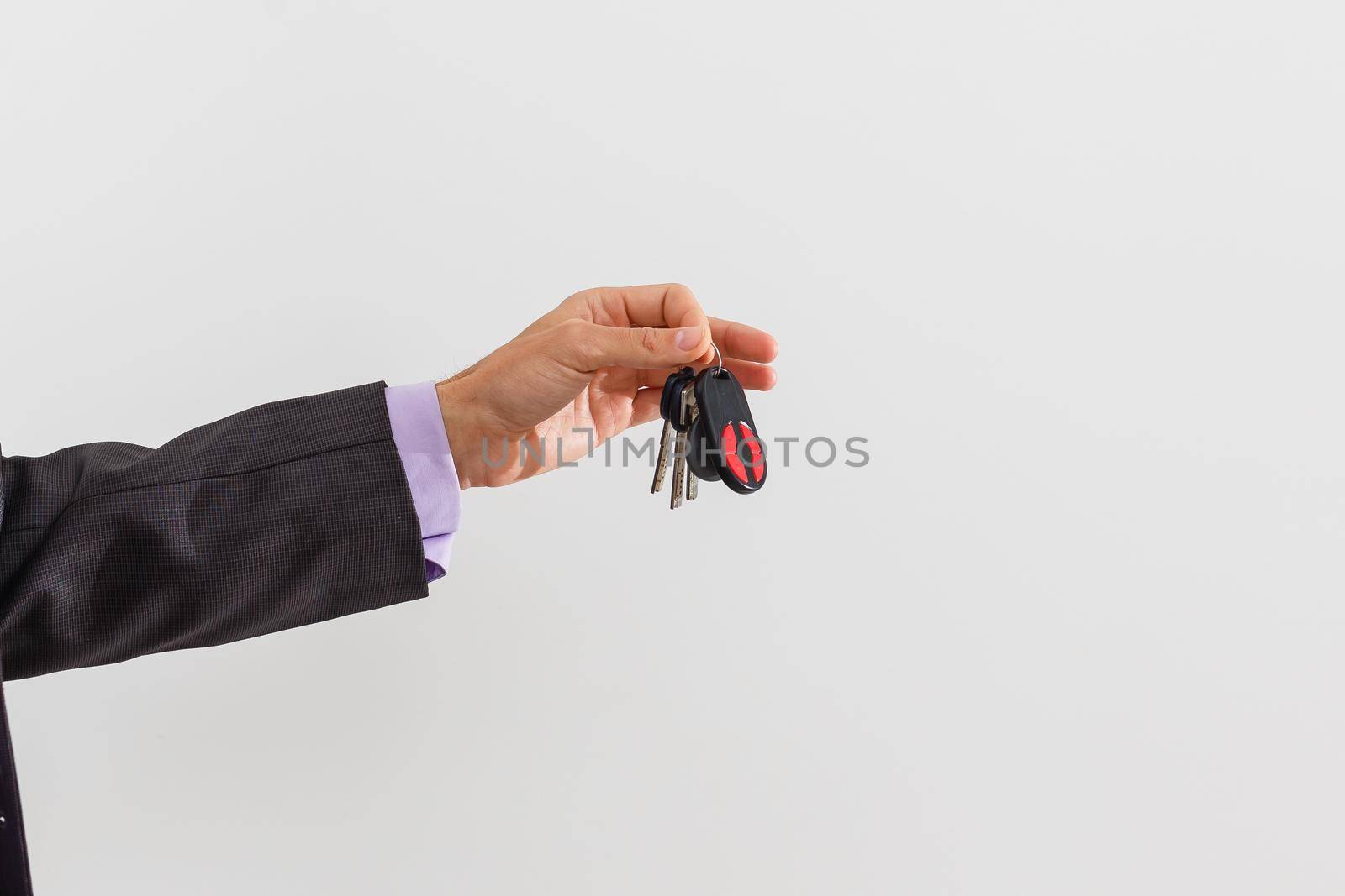 businessman holding a car key