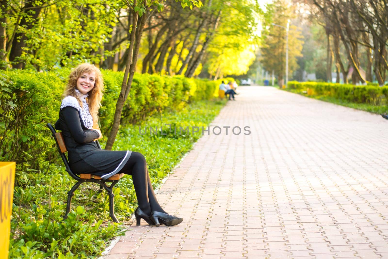 Girl is walking in the park. Cute woman with flowers